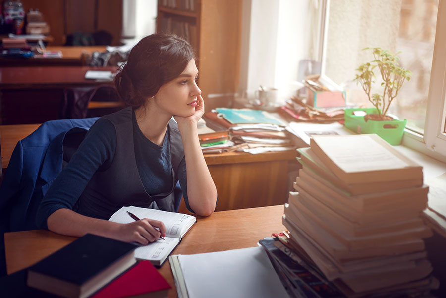 Serious woman thinking in library silence.