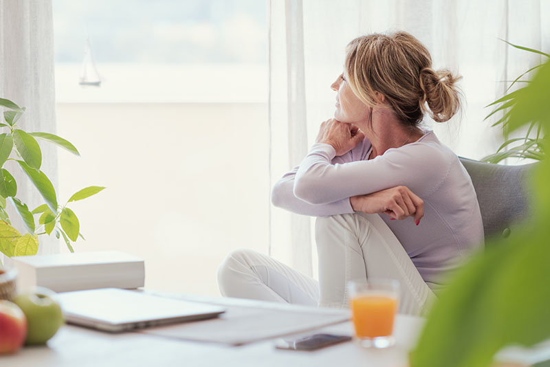 Mature woman looking out of the window
